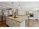 Open-concept kitchen with an island flowing into the dining and living areas at 1749 Grand Oaks Dr, Woodstock, GA 30188