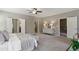 A well-lit main bedroom features doorways to closets, adjacent rooms, and plush carpet flooring at 1749 Grand Oaks Dr, Woodstock, GA 30188