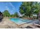 Inviting community pool surrounded by lounge chairs and lush greenery, creating a serene resort-like atmosphere at 1749 Grand Oaks Dr, Woodstock, GA 30188