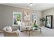 Comfortable seating area with plush sofa and chair situated in naturally lit space at 1749 Grand Oaks Dr, Woodstock, GA 30188