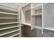 A walk-in closet showcases custom built-in shelving for optimal storage and organization at 1749 Grand Oaks Dr, Woodstock, GA 30188