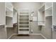 Spacious walk-in closet features custom shelving, and closet rod for clothing and organization at 1749 Grand Oaks Dr, Woodstock, GA 30188