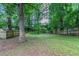 The green backyard features mature trees and a classic wooden fence at 233 Clayton St, Fairburn, GA 30213