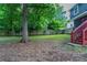 The green backyard features mature trees and a classic wooden fence at 233 Clayton St, Fairburn, GA 30213