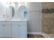 Modern bathroom boasts double sinks, tiled floors and a tiled shower at 233 Clayton St, Fairburn, GA 30213