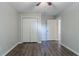 Bedroom with ceiling fan, closet, wood-look flooring, and a door leading to another room at 233 Clayton St, Fairburn, GA 30213