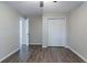 Bright bedroom featuring wood-look floors, a closet, and a door to another room at 233 Clayton St, Fairburn, GA 30213