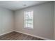 This bedroom features a large window, providing natural light and views of the outside at 233 Clayton St, Fairburn, GA 30213