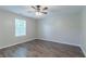 Bedroom features wood-look floors, ceiling fan, and a view out the window at 233 Clayton St, Fairburn, GA 30213