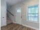 Welcoming entryway features staircase, fresh paint, and wood floors at 233 Clayton St, Fairburn, GA 30213