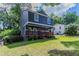 View of the home's exterior showing the front lawn and inviting porch, surrounded by trees at 233 Clayton St, Fairburn, GA 30213