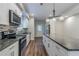 Modern kitchen features stainless steel appliances, granite countertops, and an island with pendant lighting at 233 Clayton St, Fairburn, GA 30213