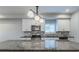 This kitchen boasts granite counters, stainless appliances, and modern lighting at 233 Clayton St, Fairburn, GA 30213