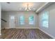 Bright living room featuring wood floors, fresh paint, and plenty of natural light at 233 Clayton St, Fairburn, GA 30213