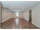 Spacious living room offers recessed lighting, neutral walls, and wood-look flooring at 233 Clayton St, Fairburn, GA 30213