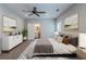 Tastefully staged main bedroom featuring carpet, a fan, and ensuite bathroom at 233 Clayton St, Fairburn, GA 30213