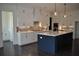 Modern kitchen features white cabinets, center island and stainless steel appliances at 333 Mont Harmony Sw Rd, Powder Springs, GA 30127