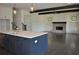 Open-concept kitchen with white cabinets, center island and a fireplace view at 333 Mont Harmony Sw Rd, Powder Springs, GA 30127