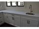 Bright kitchen has gleaming countertops, white cabinets and stainless faucet at 333 Mont Harmony Sw Rd, Powder Springs, GA 30127