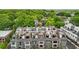 Aerial view of a modern townhome community with rooftop terraces nestled amongst lush green trees at 71 Krog Ne St, Atlanta, GA 30307