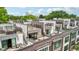 An aerial view of modern townhomes featuring rooftop patios and outdoor seating areas on a sunny day at 71 Krog Ne St, Atlanta, GA 30307