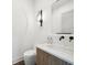 Contemporary half-bathroom with stylish sink, wood vanity, decorative mirror, and modern fixtures at 71 Krog Ne St, Atlanta, GA 30307