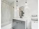 Modern bathroom with gray vanity, sleek mirror, and tiled shower-tub combination at 71 Krog Ne St, Atlanta, GA 30307