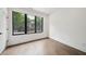 Light and airy bedroom with hardwood floors, large window, and white walls showcases simplicity at 71 Krog Ne St, Atlanta, GA 30307
