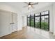 Well-lit bedroom features hardwood floors, a ceiling fan, closet space, and an oversized window at 71 Krog Ne St, Atlanta, GA 30307