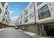 Townhome exterior with garage access and small balcony, featuring a modern design at 71 Krog Ne St, Atlanta, GA 30307