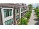 View of modern townhomes with brick and white siding, bay windows, and lush green trees at 71 Krog Ne St, Atlanta, GA 30307