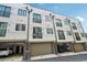 Modern townhome exterior with garage access and small balcony with black trim at 71 Krog Ne St, Atlanta, GA 30307
