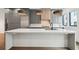 Large kitchen island featuring modern pendant lights, sleek countertops, and stainless steel appliances at 71 Krog Ne St, Atlanta, GA 30307