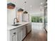 Open-concept kitchen and living area with hardwood floors, modern lighting, and stainless steel appliances at 71 Krog Ne St, Atlanta, GA 30307
