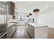 Modern kitchen boasts stainless steel appliances, large island, pendant lights, and hardwood floors at 71 Krog Ne St, Atlanta, GA 30307