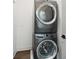 Stacked washer and dryer set in laundry area, providing convenience and space-saving design at 71 Krog Ne St, Atlanta, GA 30307