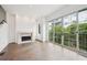 Living room features hardwood floors, a fireplace, and a sliding door to a balcony at 71 Krog Ne St, Atlanta, GA 30307