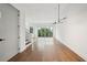 Open-concept living space with modern lighting, staircase and sliding doors to balcony at 71 Krog Ne St, Atlanta, GA 30307