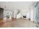 Open-concept living area with fireplace, hardwood floors, and sliding glass doors to balcony at 71 Krog Ne St, Atlanta, GA 30307