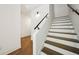 Bright staircase with white risers and dark wood treads and handrail at 71 Krog Ne St, Atlanta, GA 30307