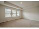 The bedroom offers neutral carpet, tray ceiling, and large windows at 123 Matson Sw Run, Mableton, GA 30126