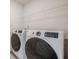 Laundry room with white washer, dryer, and wire shelving at 123 Matson Sw Run, Mableton, GA 30126