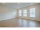 Bright, empty living room with hardwood floors and lots of natural light at 123 Matson Sw Run, Mableton, GA 30126