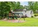 Expansive backyard features a playset, lush lawn, and mature trees at 2166 Carlyle Dr, Marietta, GA 30062