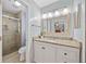 Bathroom featuring granite counters, white vanity, and glass-enclosed shower at 2166 Carlyle Dr, Marietta, GA 30062