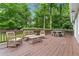 Outdoor deck with seating area and table overlooks a serene, wooded landscape at 2166 Carlyle Dr, Marietta, GA 30062