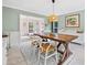 Open dining room with rustic table, white chairs, and view to living area at 2166 Carlyle Dr, Marietta, GA 30062