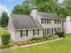 Two-story home with gray siding, dark shutters, and a lush green lawn at 2166 Carlyle Dr, Marietta, GA 30062
