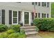 Inviting front entrance with stone steps, fresh landscaping, and a charming American flag at 2166 Carlyle Dr, Marietta, GA 30062