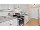 Well-lit kitchen features granite countertops, white cabinets, stainless steel appliances, and herringbone backsplash at 2166 Carlyle Dr, Marietta, GA 30062